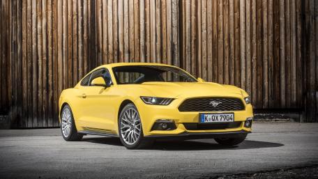 Vibrant Yellow Muscle Car on Display wallpaper