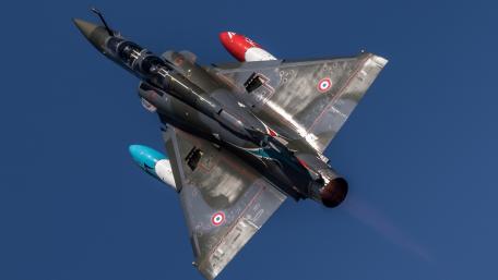 Fighter Jet in Action Above the Clouds wallpaper