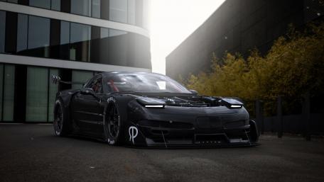 Sleek Black Racing Car in Urban Setting wallpaper