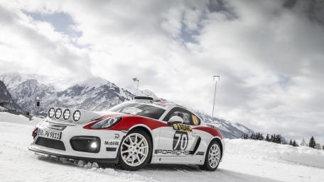 Stunning Porsche Racing Through Snowy Mountains wallpaper