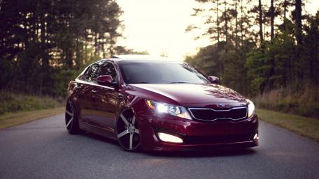 Sleek Red Sedan Showcasing Automotive Elegance wallpaper