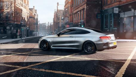 Sleek Silver Coupe on a Snowy Street wallpaper
