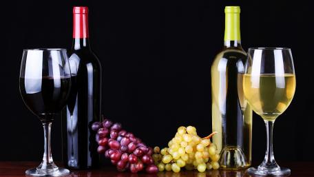 Wine Bottles and Grapes Displaying Elegance and Taste wallpaper