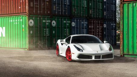 Sleek White Supercar Among Colorful Containers wallpaper