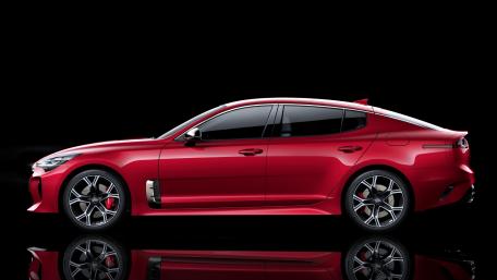 Sleek Red Performance Sedan in Black Background wallpaper