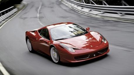 Red Ferrari on a Curvy Road for Enthusiasts wallpaper