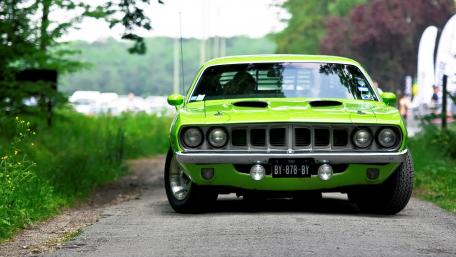 Classic Green Muscle Car on Scenic Roadway wallpaper