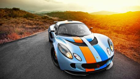 Sleek Racing Car on a Scenic Road wallpaper