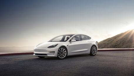 Sleek White Tesla Model 3 on Coastal Roadway wallpaper