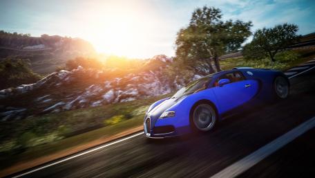 Sleek Blue Sports Car in Motion Amidst Nature's Beauty wallpaper