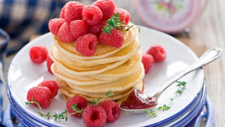 Delicious Pancakes with Fresh Raspberries and Syrup wallpaper