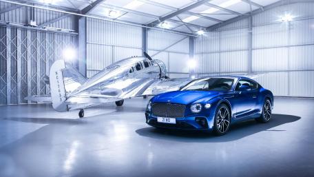 Sleek Blue Beauty and Vintage Aircraft Together wallpaper