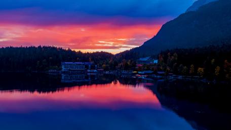 Vibrant Sunset Over Tranquil Lake Scene wallpaper