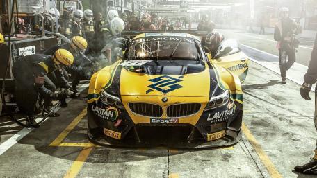 Racing Action in the Pit Lane Scene wallpaper