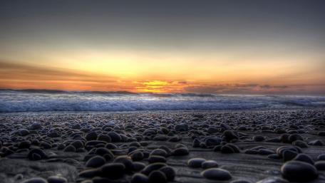 Serene Sunset over Rocky Shoreline wallpaper