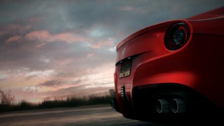 Sleek Red Sports Car Under Dramatic Sky wallpaper