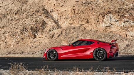 Sleek Red Sports Car on a Desert Road wallpaper