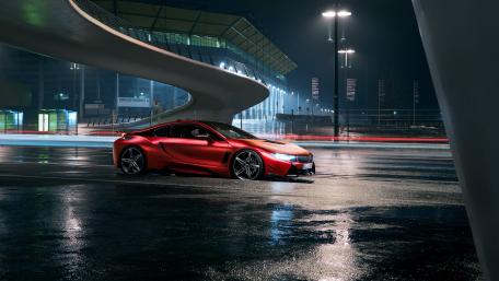 Sleek Red Sports Car Under Night Lights wallpaper