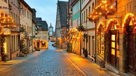 Charming Cobblestone Street in Festive Lights wallpaper