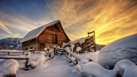 Cozy Winter Cabin at Sunset wallpaper