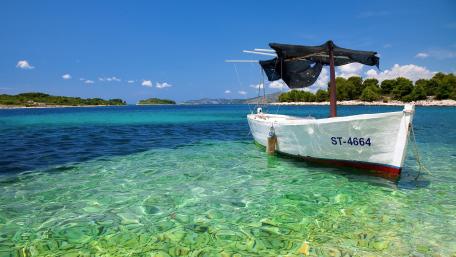 Serene Waters with a Rustic Boat wallpaper