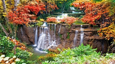 Serene Waterfalls Amidst Vibrant Autumn Foliage wallpaper