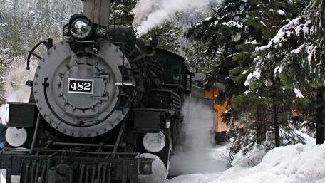 Classic Steam Engine in a Winter Wonderland Scene wallpaper