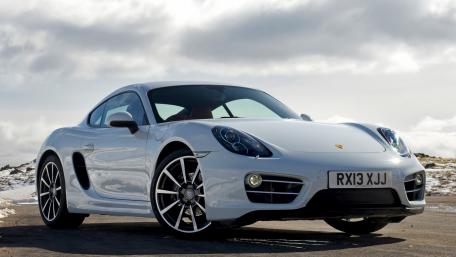 Sleek White Sports Car on a Scenic Roadview wallpaper