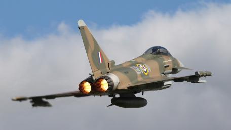 Fighter Jet in Action Above the Clouds wallpaper