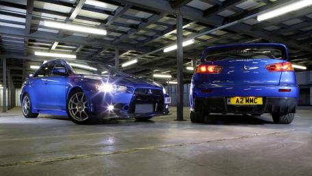 Sleek Blue Cars in an Industrial Setting wallpaper