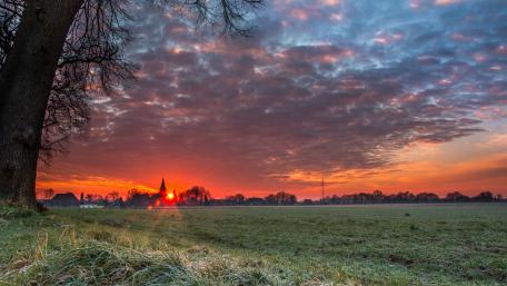 Stunning Sunrise Over a Serene Landscape wallpaper