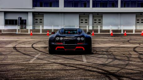 Sleek Black Supercar on a Track wallpaper