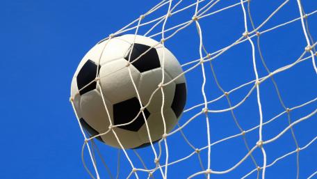 Soccer Ball in Goal Against a Clear Sky wallpaper