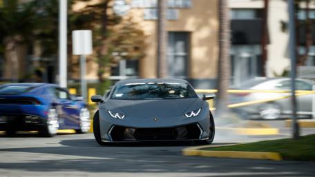 Sleek Lamborghini Racing Through Urban Streets wallpaper