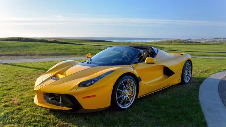 Sleek Yellow Supercar on Scenic Coastline wallpaper