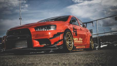 Sleek Red Car in Dynamic Setting wallpaper