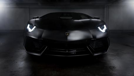 Sleek Black Lamborghini in Mysterious Lighting wallpaper