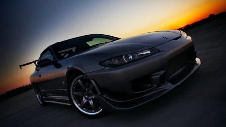 Stunning Sunset Drive with a Sleek Sports Car wallpaper