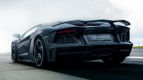 Sleek Black Supercar in Motion wallpaper