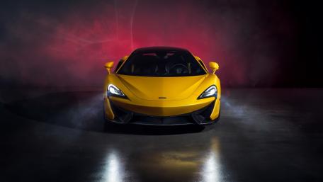 Dynamic Yellow Sports Car in Dramatic Lighting wallpaper