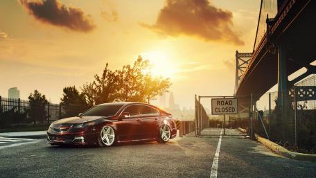 Sleek Car Under Sunset Glow wallpaper