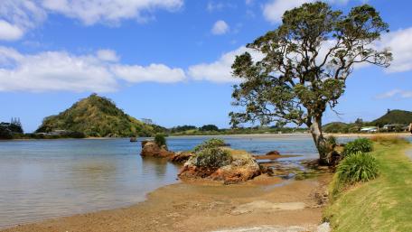 Serene Coastal Landscape Under Clear Blue Skies wallpaper