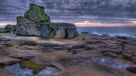 Serene Coastal Landscape Under Cloudy Skies wallpaper