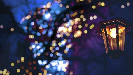 Illuminated Lantern Amidst Colorful Bokeh Effects wallpaper