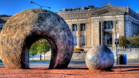 Urban Sculpture in Vibrant City Setting wallpaper