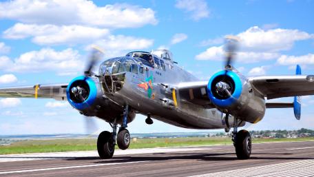 Classic Bomber Taking Off in Clear Blue Skies wallpaper