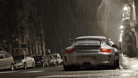 Sleek Sports Car in Rainy Cityscape wallpaper