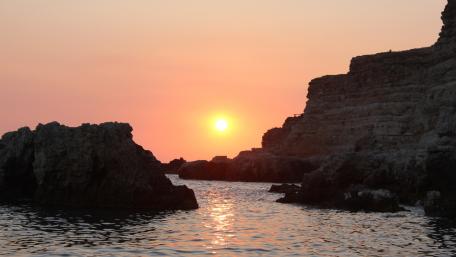 Serene Sunset Over Rocky Coastline wallpaper