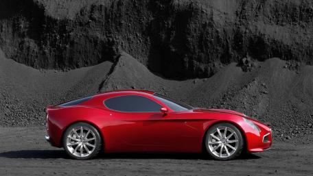 Sleek Red Sports Car Against Dark Backdrop wallpaper