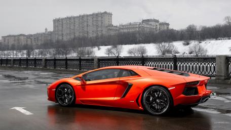 Sleek Orange Lamborghini on a Rainy Day wallpaper